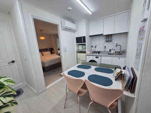 a kitchen with a table and chairs in a room at Forest Hangang in Seoul