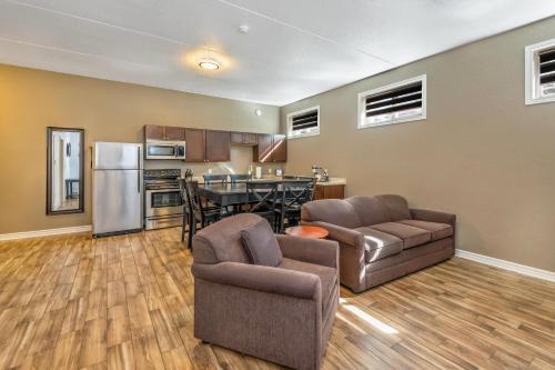 a living room with two couches and a kitchen at Comfort Inn & Suites Thousand Islands Harbour District in Gananoque