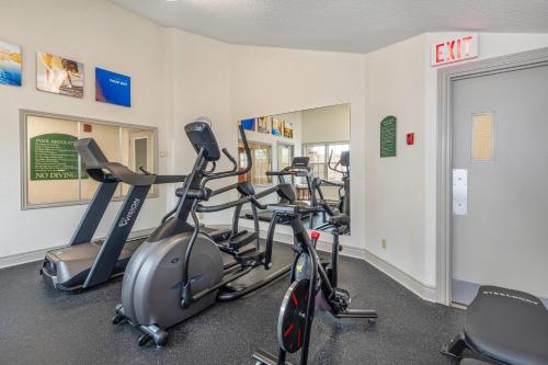 a gym with three exercise bikes in a room at Comfort Inn & Suites Thousand Islands Harbour District in Gananoque