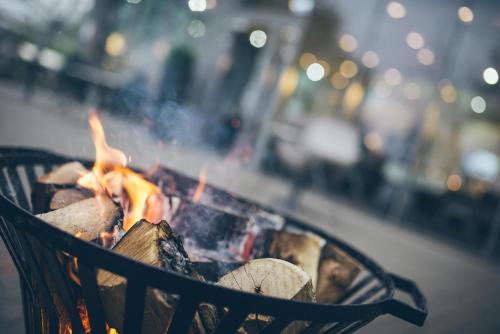 a grill with a fire in it on a street at Best Western Plus Lakeside Hotel in Székesfehérvár