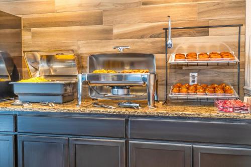 a kitchen with a counter with some pastries on at Comfort Inn & Suites Thousand Islands Harbour District in Gananoque