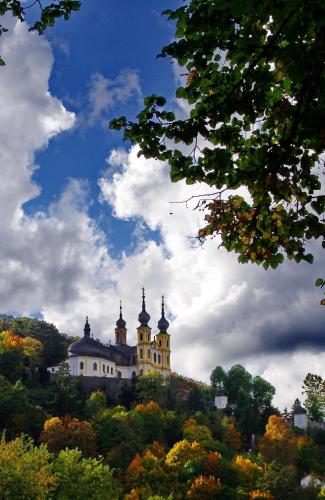 a building on top of a hill with trees at Best Western Hotel Würzburg-Süd in Würzburg