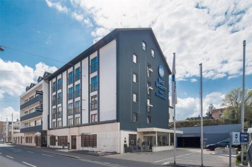 a large building on the corner of a street at Best Western Hotel Würzburg-Süd in Würzburg