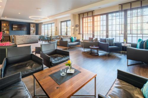 a lobby with couches and tables and windows at Best Western Hotel Würzburg-Süd in Würzburg