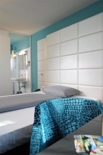 a bedroom with a bed with a large mirror at Best Western Hotel Würzburg-Süd in Würzburg