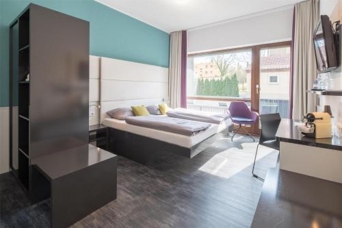 a bedroom with a bed and a large window at Best Western Hotel Würzburg-Süd in Würzburg