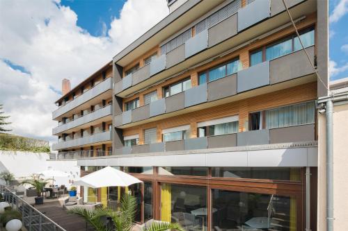 an external view of a building with a patio at Best Western Hotel Würzburg-Süd in Würzburg