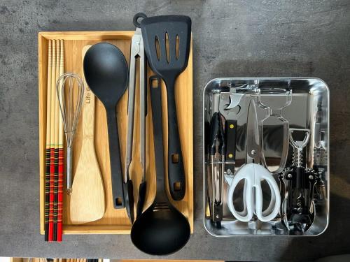 a container filled with kitchen utensils on a table at Nicostay Katsuura Beach in Fukuoka