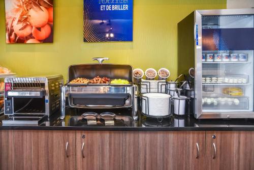 a kitchen with a counter with food on it at Comfort Inn in Swift Current