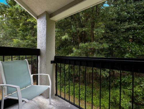 a blue chair sitting on a balcony with a view at Sleep Inn Savannah Midtown in Savannah
