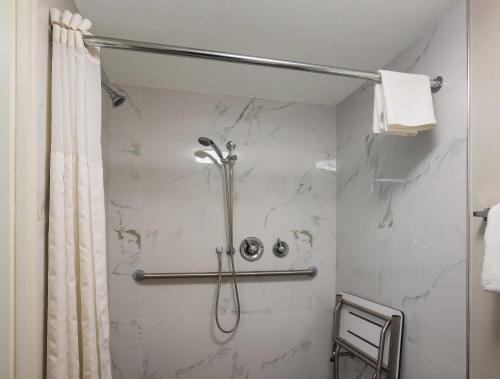 a bathroom with a shower with a shower curtain at Sleep Inn Savannah Midtown in Savannah