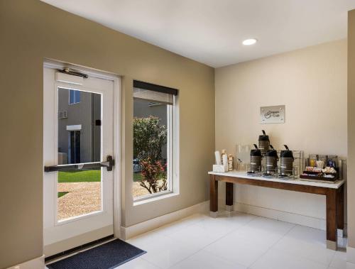 a room with a door and a counter with a window at Sleep Inn Savannah Midtown in Savannah
