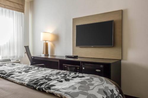 a hotel room with a bed and a flat screen tv at Sleep Inn Philadelphia Center City in Philadelphia