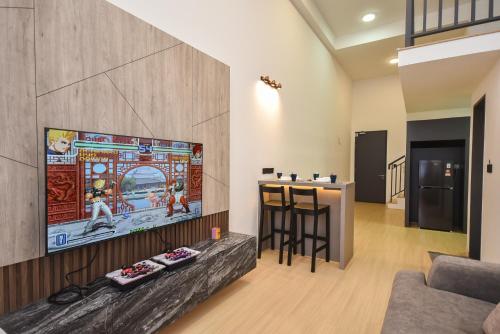 a living room with a tv and a bar at Sunway Grid Loft Suite by Nest Home【Olympic Size Pool】 in Kampong Pendas