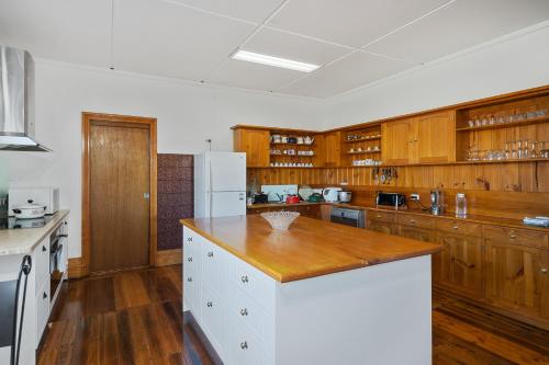 a kitchen with wooden cabinets and a wooden counter top at Franklin Lodge Huon Valley Iris Room in Franklin