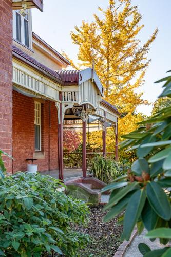 a porch of a brick house with avisor on it at Franklin Lodge Huon Valley Iris Room in Franklin