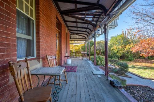 a porch of a house with a table and chairs at Franklin Lodge Huon Valley Iris Room in Franklin