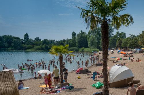 a group of people on the beach at a lake at Design-Apartments by Ulrike Horster in Bensheim