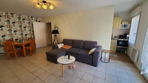 un salon avec un canapé et une table dans l'établissement T2 Apt Berck avec parking, 1.8km plage, à Berck-sur-Mer