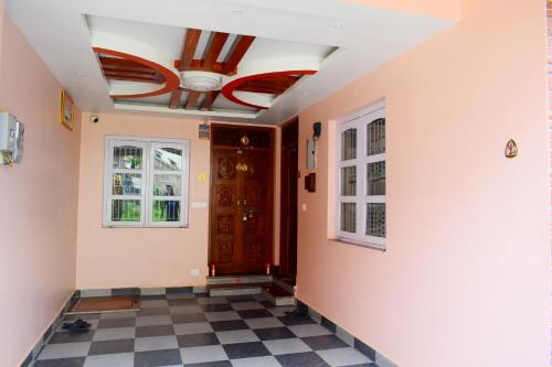 a hallway with a ceiling fan and a checkered floor at The Pahuna Apartment in Bālāju