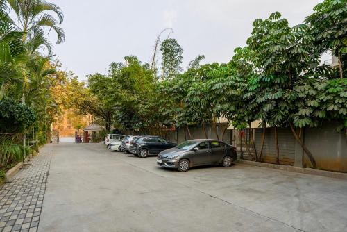 a row of cars parked in a parking lot at Treebo Premium Niraali Executive, Hinjewadi in Pune