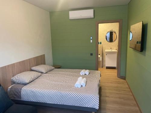 a bedroom with a bed with two towels on it at Vila Kalniškiai in Varkaliai