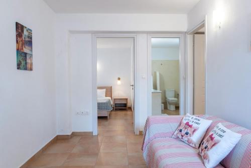 a living room with a couch and a bedroom at Blue Xenia Villas Paros in Chrissi Akti
