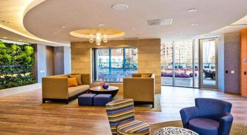 a lobby with couches and chairs in a building at Capital O 91820 S&a Collection 2 in Jakarta