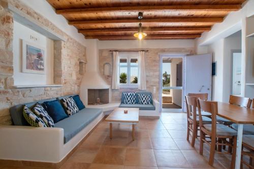 a living room with a couch and a table at Blue Xenia Villas Paros in Chrissi Akti