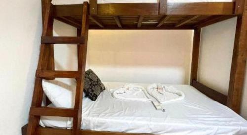 a bunk bed with two white clothes on it at Pilot Hotel in Alaminos