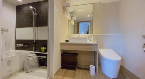 a bathroom with a sink and a toilet and a shower at KEIKYU EX INN Hamamatsucho Daimon-Station (Tokyo) in Tokyo