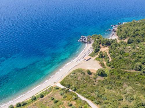 an aerial view of a beach next to the ocean at Ajul Luxury Hotel & Spa Resort, a Registry Collection Hotel in Agia Paraskevi