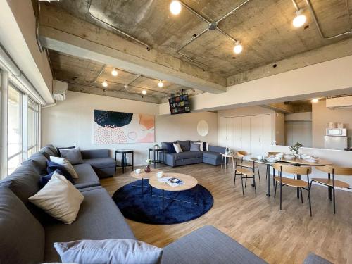 a living room with a couch and a table at b hotel Dai3Himawari - Amazing Dome View 30 sec PeacePark, Up to 10 ppl in Hiroshima