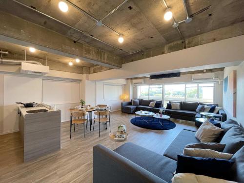 a living room with a couch and a table at b hotel Dai3Himawari - Amazing Dome View 30 sec PeacePark, Up to 10 ppl in Hiroshima