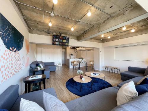 a living room with a couch and a table at b hotel Dai3Himawari - Amazing Dome View 30 sec PeacePark, Up to 10 ppl in Hiroshima