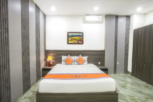 a bedroom with a large bed in a room at Premium CGP Hotel Hoi An in Hoi An
