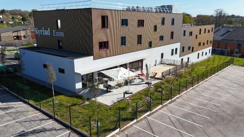 an overhead view of a building with a parking lot at Kyriad Limoges - Ester in Limoges