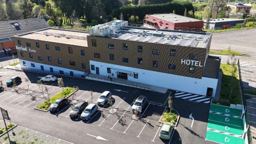 an aerial view of a hotel with cars parked in a parking lot at Kyriad Limoges - Ester in Limoges