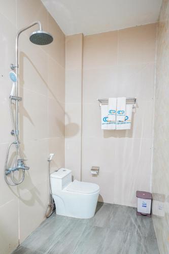a white bathroom with a toilet and a shower at Premium CGP Hotel Hoi An in Hoi An