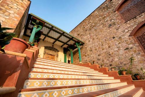 a set of stairs in front of a building at Haveli Anirudh - Royalty Redefined in Jaipur