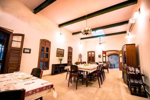 a dining room with a table and chairs at Haveli Anirudh - Royalty Redefined in Jaipur