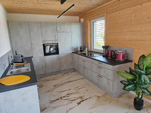 a large kitchen with a sink and a stove at Ferienwohnung Stadtblick 13 in Pfullendorf