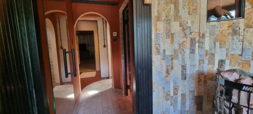 a hallway of a house with a tile wall at Étang des Tamaris in Namur