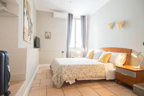a white bedroom with a bed and a window at B&b My Bergamo in Bergamo