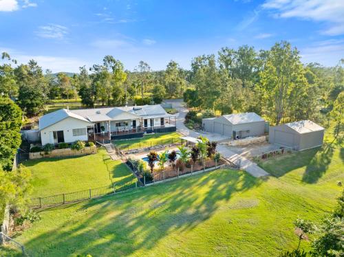 an aerial view of a house with a yard at Riverbend Ranch Tamborine in Tamborine