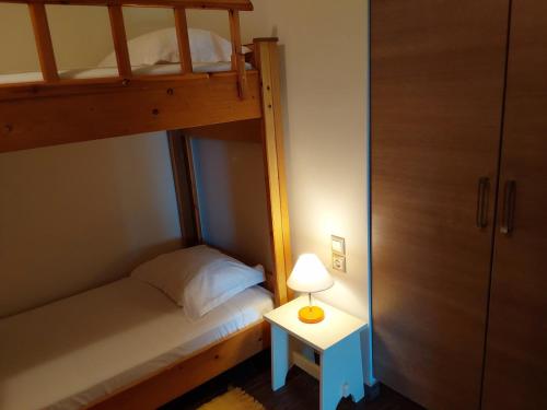 a bedroom with a bunk bed and a table with a lamp at Villa Polyxeni 5 Bedrooms and Private Pool in Politiká