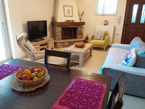 a living room with a table with a bowl of fruit at Villa Polyxeni 5 Bedrooms and Private Pool in Politiká