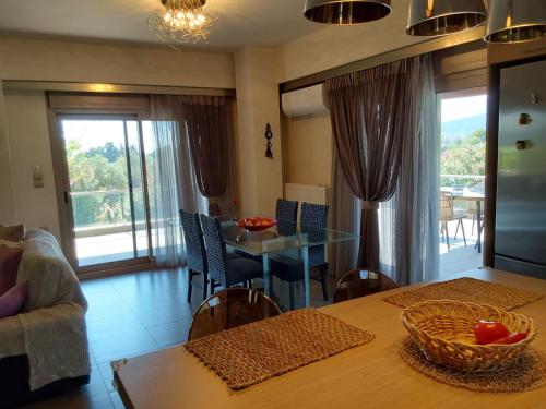 a kitchen with a table and a dining room with a view at Villa Polyxeni 5 Bedrooms and Private Pool in Politiká