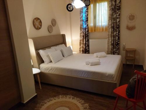 a bedroom with a bed with two towels on it at Villa Polyxeni 5 Bedrooms and Private Pool in Politiká