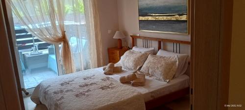 a bedroom with a bed with two shoes on it at Armira House in Nea Moudania